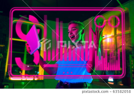 Woman using interface modern technology and digital layer effect as business, finance, economics strategy concept Woman using interface modern technology and digital layer effect as business, finance, economics strategy concept 63582058