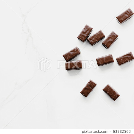 Dark chocolate candies isolated on white background, sweet food and dessert 63582563