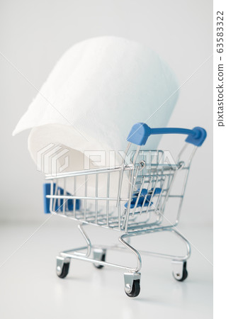 Roll of toilet paper in a decorative shopping trolley. Concept of shortage of goods, panic and 63583322