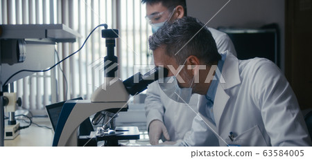 Scientist looking at camera in laboratory 63584005