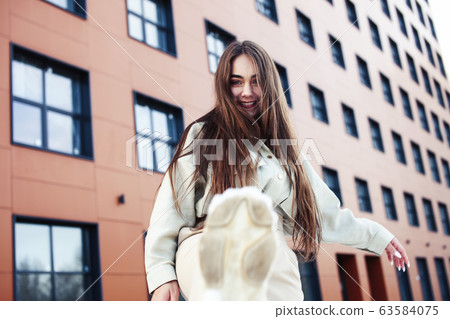 young pretty teenage girl posing cheerful happy smiling wearing street style outside in europe city, lifestyle people concept young pretty teenage girl posing cheerful happy smiling wearing street style outside in europe city, lifestyle people concept 63584075