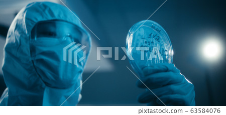 Scientist examining coronavirus sample in laboratory Scientist examining coronavirus sample in laboratory 63584076