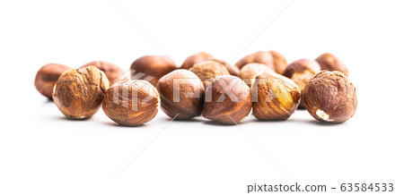 Peeled hazelnuts on white background. 63584533