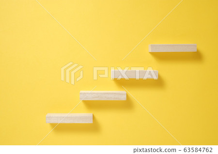 Building blocks lined up to the right with a yellow background rising image Building blocks lined up to the right with a yellow background rising image 63584762