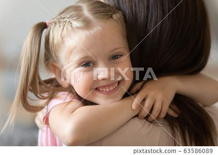 Cute little girl hug mom showing love Cute little girl hug mom showing love 63586089
