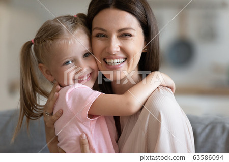 Portrait of happy mom and daughter hugging Portrait of happy mom and daughter hugging 63586094