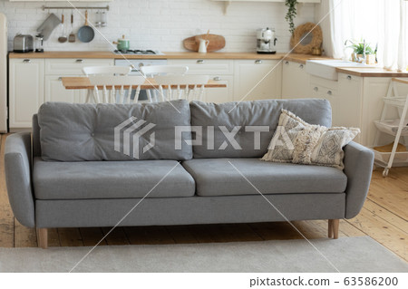 Grey comfy sofa in cozy countryside house 63586200