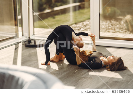 Woman with daughter is engaged in gymnastics 63586466