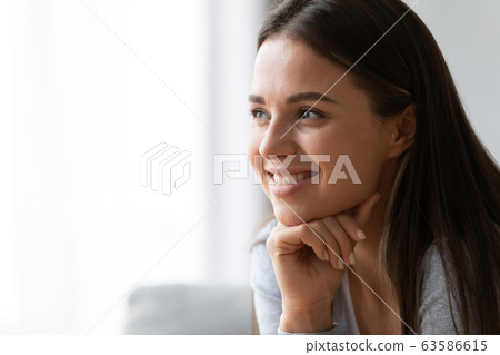 Happy young woman look in distance dreaming or visualizing 63586615