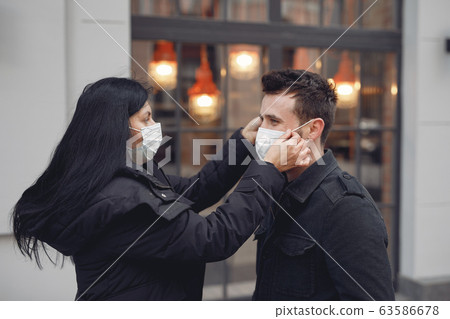 People in a masks stands on the street People in a masks stands on the street 63586678