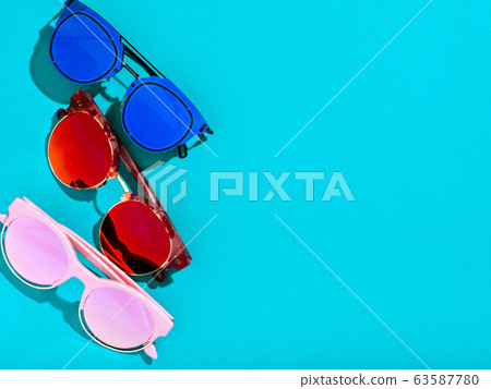 Summer background with three colourful sunglasses. Summer background with three colourful sunglasses. 63587780