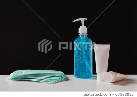Sanitizer gel bottle and masks to prevent viruses. 63588052