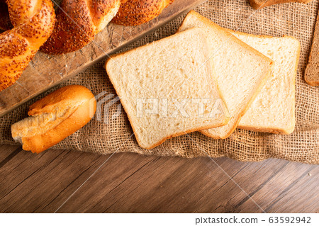 Slices of white bread with bagels and baguette 63592942