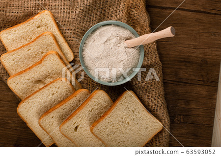 A bowl of flour with slices of bread A bowl of flour with slices of bread 63593052