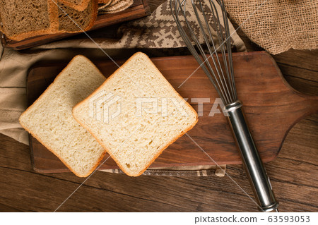 Slices of white bread on kitchen board Slices of white bread on kitchen board 63593053