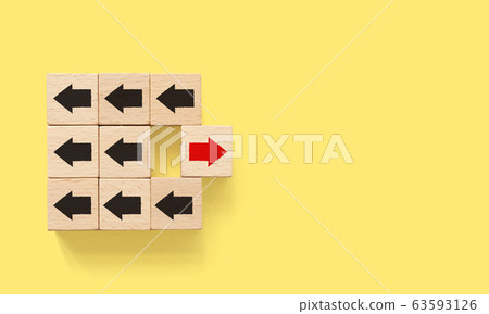 Wooden block with red arrow facing the opposite direction black arrows 63593126