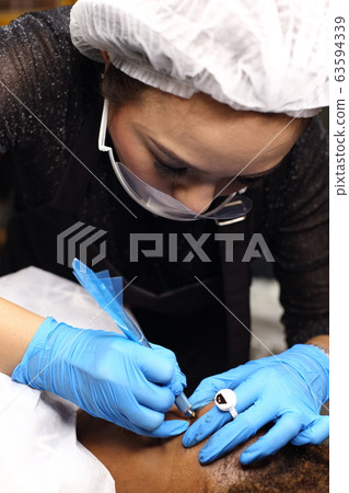 applying Tottoo, Brow Microblading to customer applying Tottoo, Brow Microblading to customer 63594339