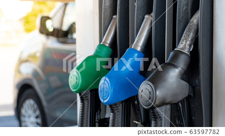 Oil fuel filling nozzles at petrol station 63597782