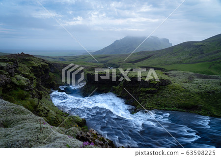 Beautiful smooth waterfall in Iceland during evening dusk Beautiful smooth waterfall in Iceland during evening dusk 63598225