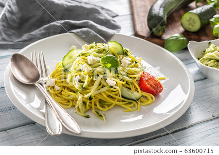 Spaghetti zucchini raw vegan pasta with feta Spaghetti zucchini raw vegan pasta with feta 63600715
