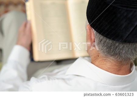 An old man reading the book. Selective focus An old man reading the book. Selective focus 63601323
