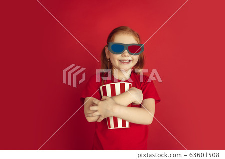 Caucasian little girl portrait isolated on red studio background, emotions concept Caucasian little girl portrait isolated on red studio background, emotions concept 63601508