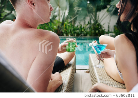 Young couple drinking tasty refreshing cocktails 63602811