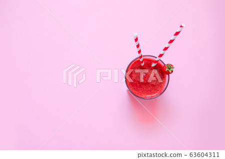 Glass of fresh strawberry milkshake, smoothie and fresh strawberries on pink background. Healthy food and drink concept. 63604311