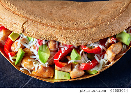Savory pancake stuffed with avocado and chicken Savory pancake stuffed with avocado and chicken 63605024