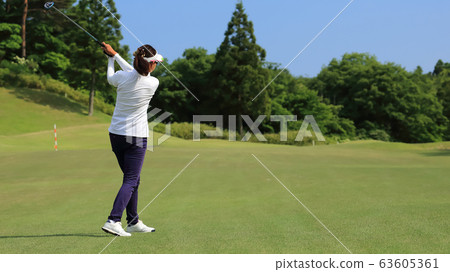 Woman hitting the tee shot 63605361