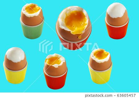 Isolated soft boiled eggs in colorful cups Isolated soft boiled eggs in colorful cups 63605457