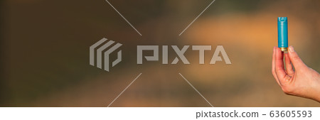 Hand holding wasted hunting cartridge with text space 63605593