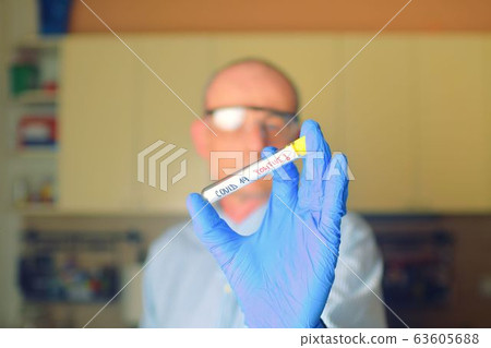 Doctor holds COVID 19 Coronavirus vaccine in his hand, infected sample in the sample tube, Vaccine and syringe injection It use for prevention, immunization and treatment from COVID-19. Doctor holds COVID 19 Coronavirus vaccine in his hand, infected sample in the sample tube, Vaccine and syringe injection It use for prevention, immunization and treatment from COVID-19. 63605688