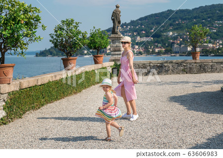 Mother and daughter dancing on the island of Isola Bella on Lake Maggiore Mother and daughter dancing on the island of Isola Bella on Lake Maggiore 63606983