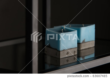 blue candle on a concrete base blue candle on a concrete base 63607485