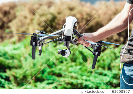 Man calibrating black and white copter 63608567