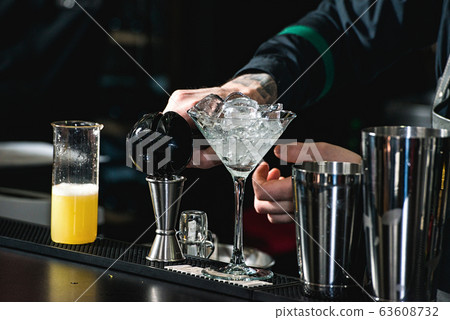bartender making relaxing coctail on a bar bartender making relaxing coctail on a bar 63608732