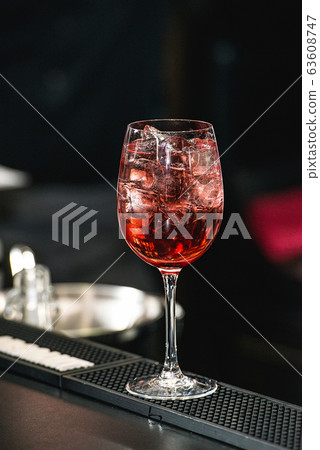 bartender making refreshing pink coctail with a bartender making refreshing pink coctail with a 63608747