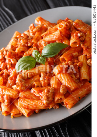Tasty Tortiglioni pasta bolognese with basil Tasty Tortiglioni pasta bolognese with basil 63609442
