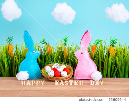 Easter background with eggs, rabbits and green grass Easter background with eggs, rabbits and green grass 63609644
