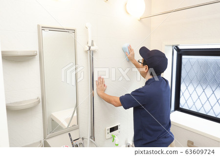 House cleaning male worker cleaning bathroom 63609724
