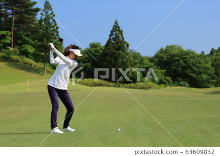Woman hitting the tee shot 63609832