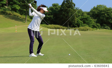 Woman hitting the tee shot 63609841