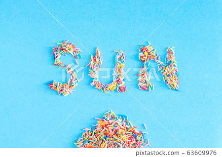 Colorful pastry sprinkes background. "Sun" word Colorful pastry sprinkes background. "Sun" word 63609976