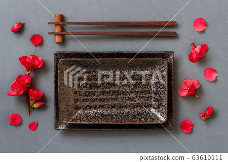 Chopsticks, rectangular plate and pink flowers on 63610111