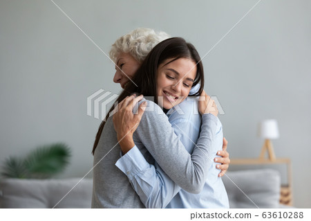Happy senior mother and grown-up daughter hugging at home 63610288