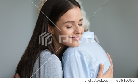 Happy millennial girl hug show love to elderly mother 63610396