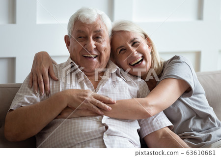 Happy older wife and husband hugging and laughing together 63610681