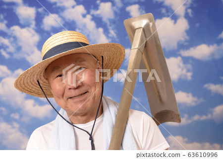 Senior farmer with hoe Senior farmer with hoe 63610996