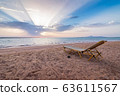 Lonely sunbed on beach 63611567